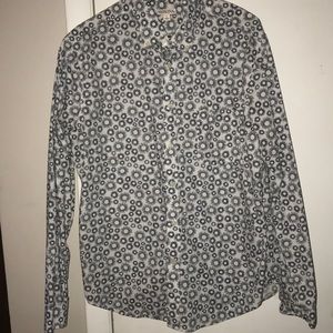 White button-up shirt with black designs.